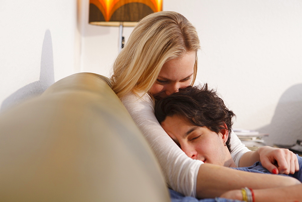 Young couple relaxing on the sofa, Embrassing