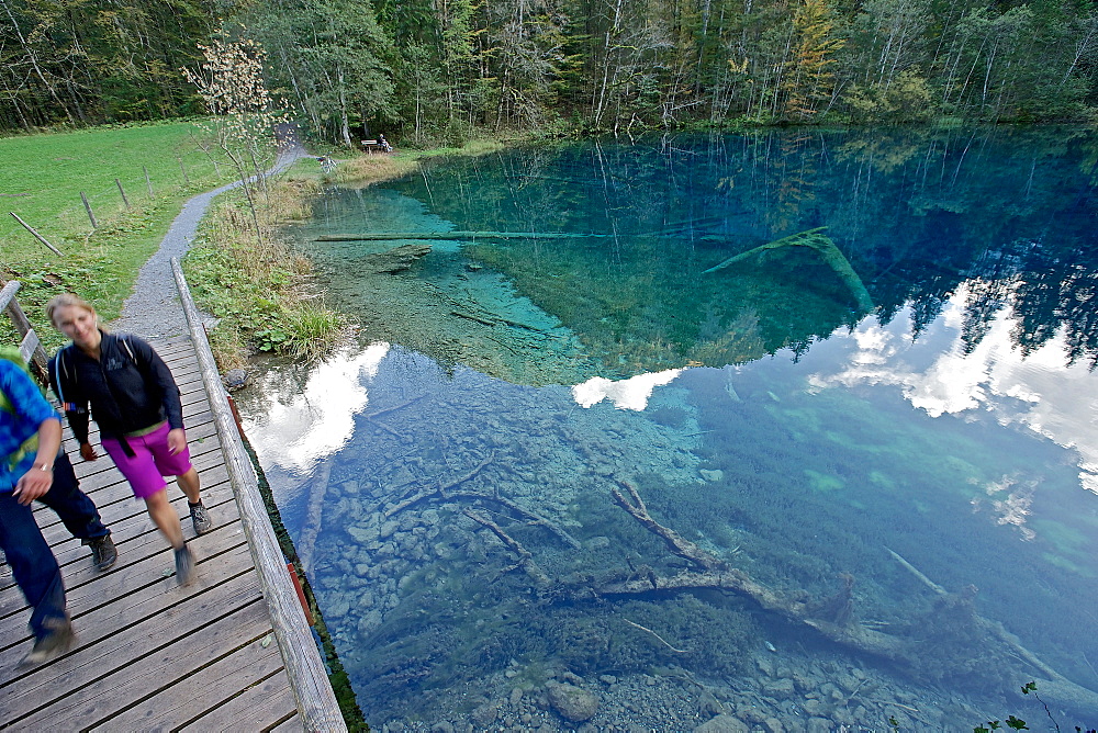 A man and a woman hiking at a small lake, Oberstdorf, Bavaria, Germany