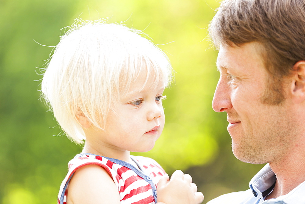 two-year-old girl in her father's arms, Speyer, Rheinland-Pfalz, Germany