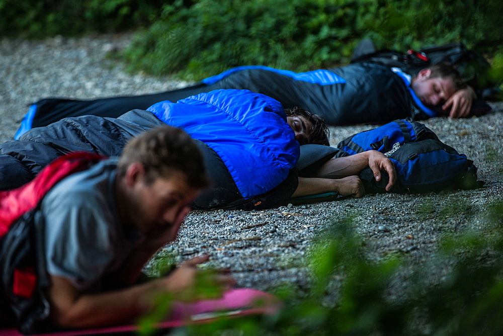 Three young men camping at a lake, Freilassing, Bavaria, Germany