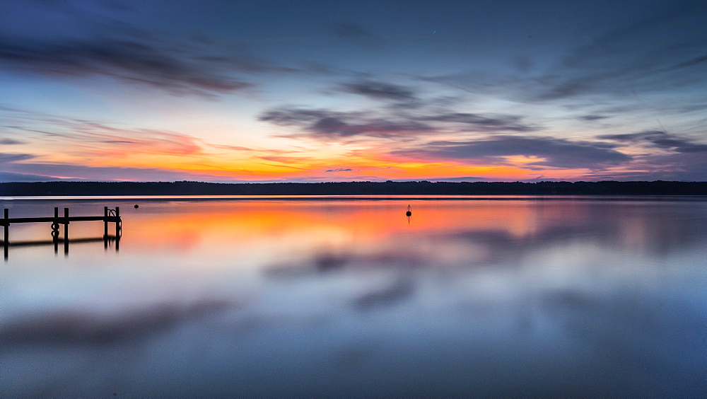 Jetty at sunrise on Lake Starnberg, Bavaria, Germany