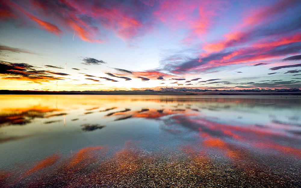 Sunrise with reflective clouds on Lake Starnberg, Bavaria, Germany