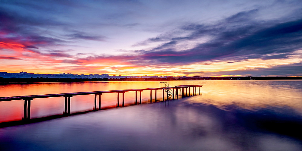 Jetty at sunset on Lake Starnberg, St. Heinrich, Bavaria, Germany