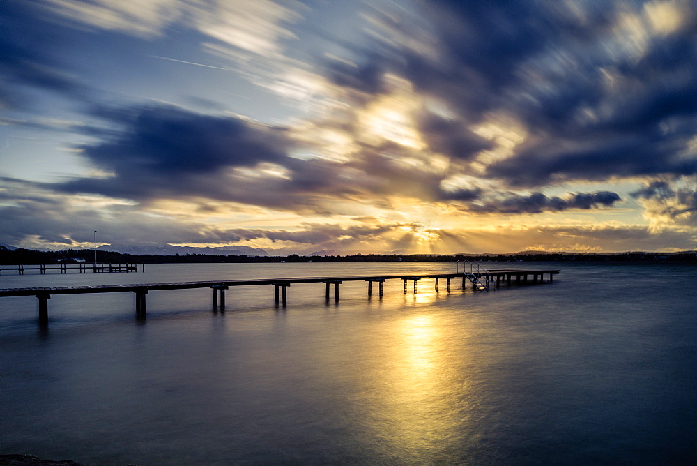 Jetty at sunset on Lake Starnberg, St. Heinrich, Bavaria, Germany