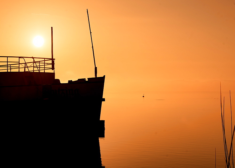 Silhouette ship (museum ship) at sunrise on Lake Starnberg, Tutzing, Bavaria, Germany