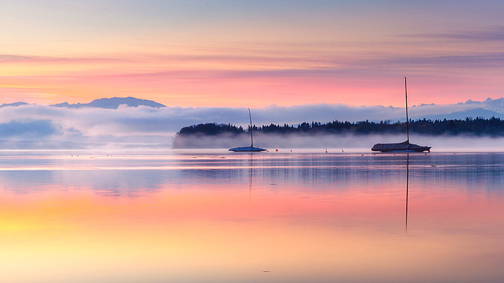 Sailboats on Lake Starnberg in the morning fog at sunrise, Tutzing, Bavaria, Germany