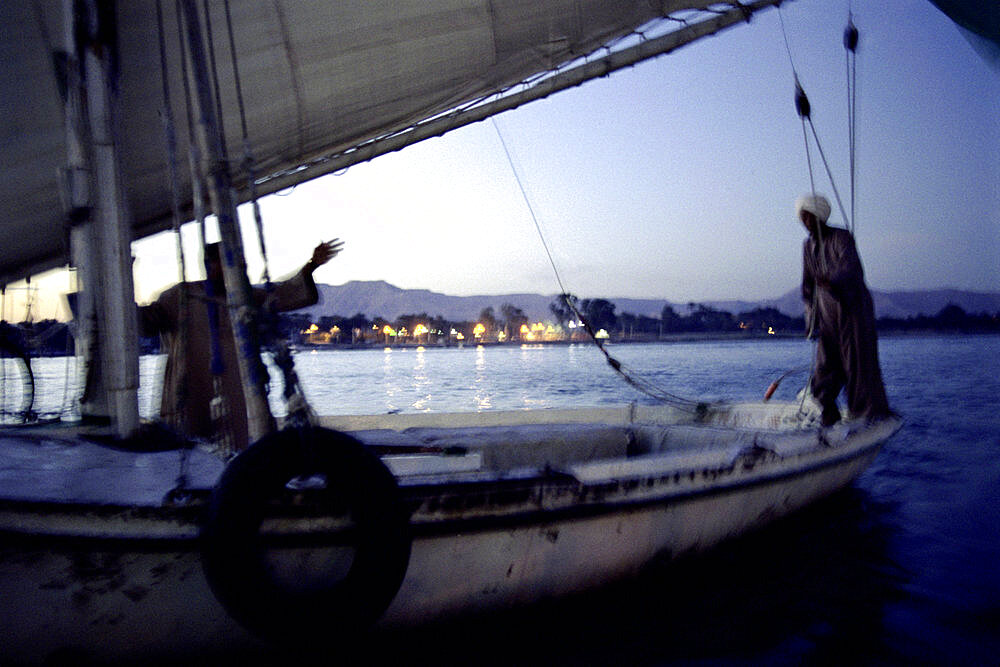 men on a sailing boat, nile, luxor, egypt