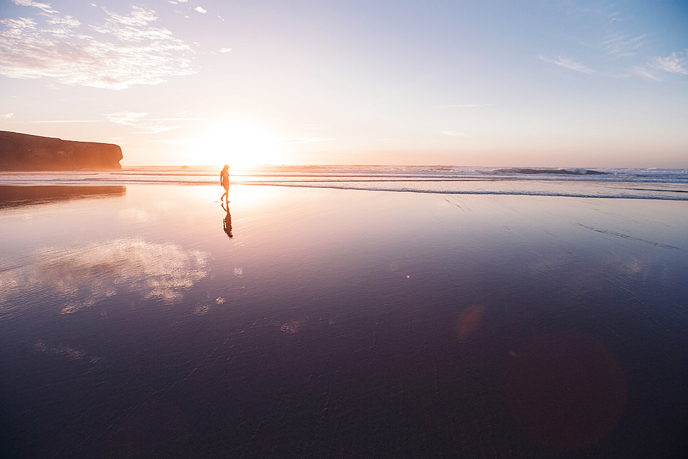 Woman walks on the beach in sunset, Portugal, beach, vacation