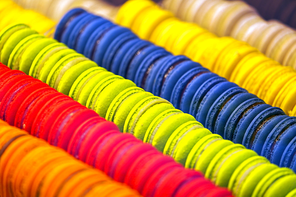 Close-up of colourful macaroons all in a row in store showcase, Luxembourg City, Luxembourg