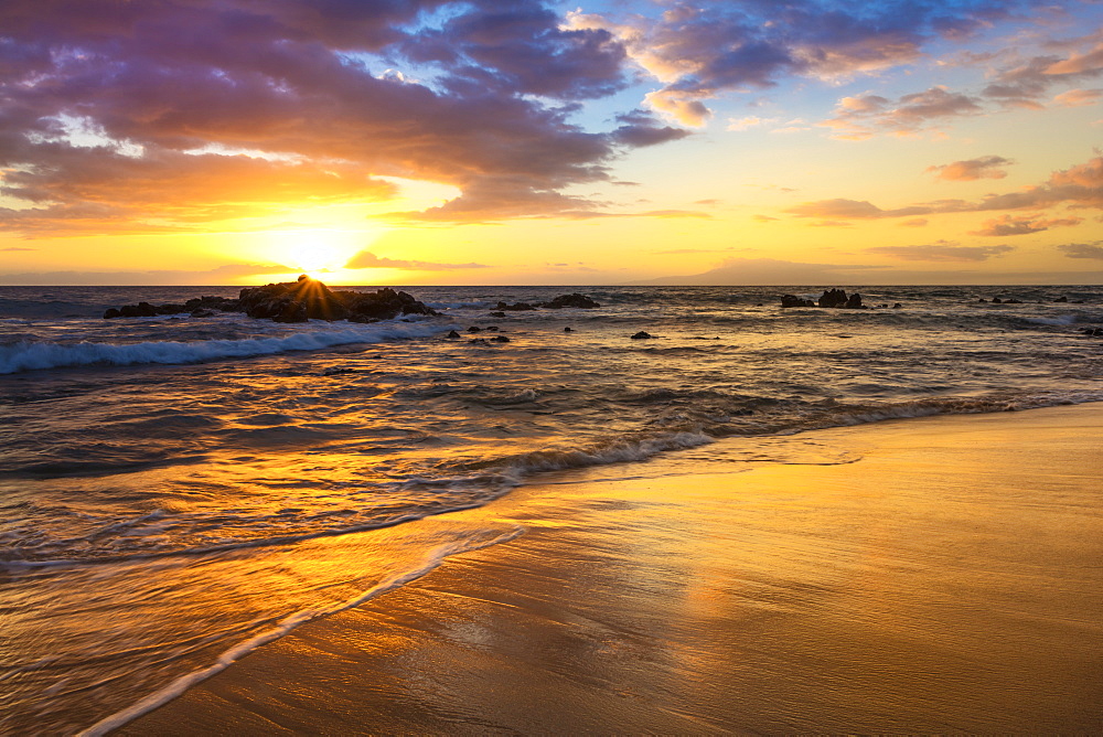 A golden sunset with reflection on sand at Ulua Beach, Wailea, Maui, Hawaii, United States of America