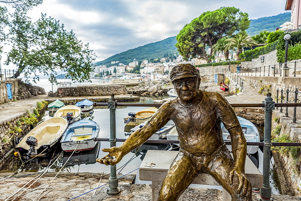 Fisherman sculpture with coins in it's hand in a harbour, Opatija, Primorje-Gorski Kotar County, Croatia