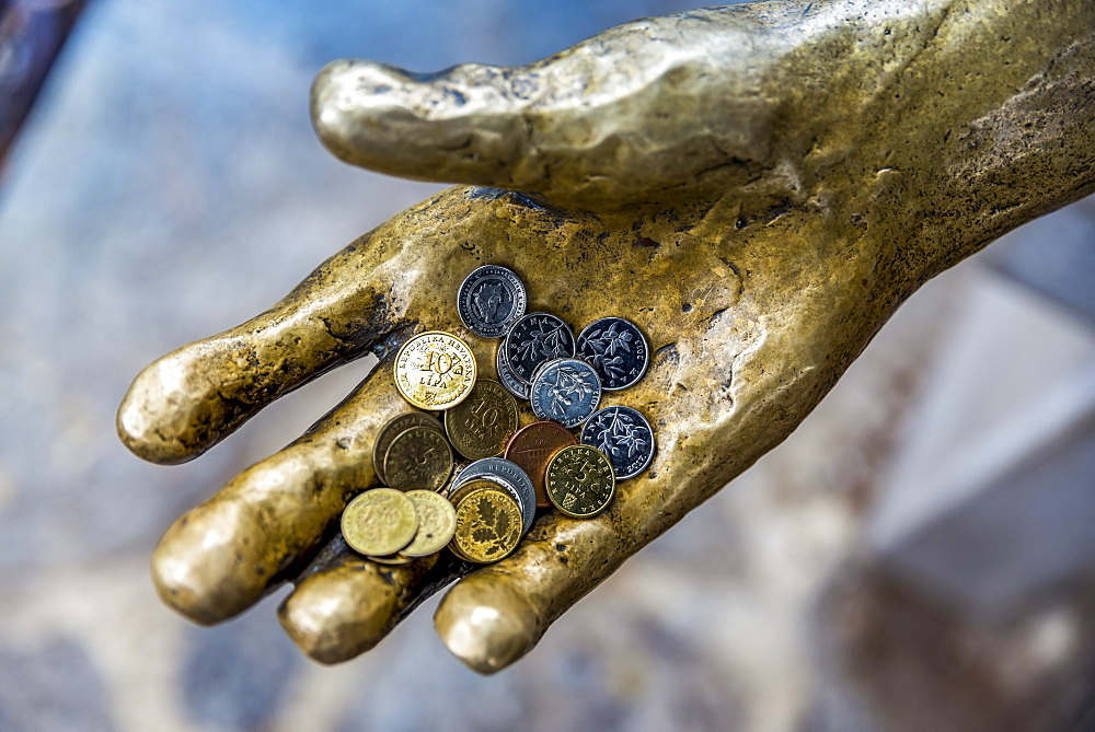 Fisherman sculpture with coins in it's hand in a harbour, Opatija, Primorje-Gorski Kotar County, Croatia