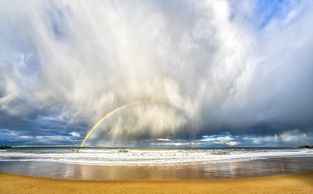 Rainbow through storm clouds viewed from a beach, South Shields, Tyne and Wear, England