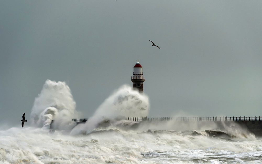 Roker Lighthouse and waves from the River Ware crashing onto the pier, Sunderland, Tyne and Wear, England