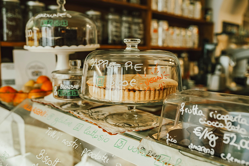 Display of confectioneries behind glass at a bakery, Italy