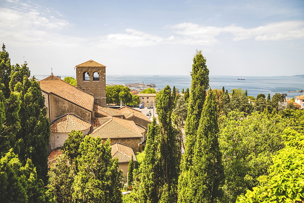 Terracotta tiled roof of a building and a view of the Adriatic Sea, Trieste, Friuli Venezia Giulia, Italy