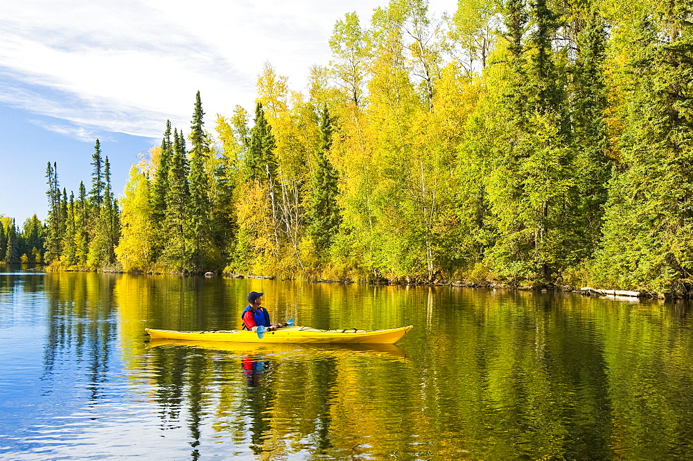 A man kayaking at MacKay Lake, Northern Saskatchewan, Saskatchewan, Canada