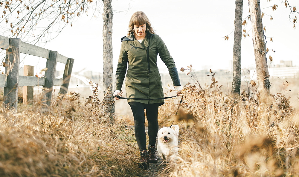 Woman walking her dog, Edmonton, Alberta, Canada