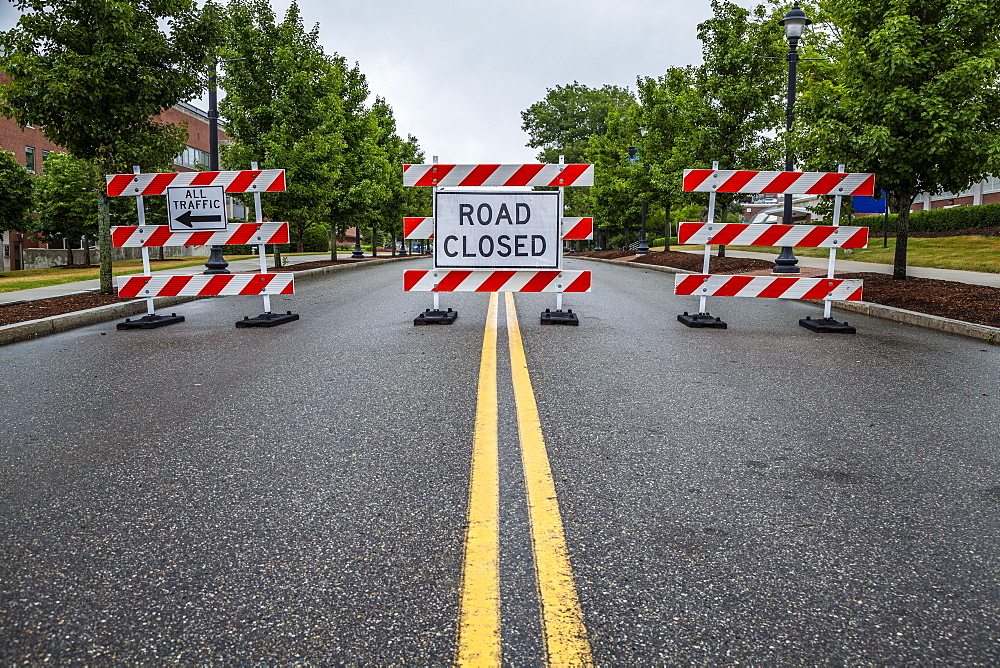 Double yellow line on a street with traffic barriers and 'Road Closed' sign, Connecticut, United States of America