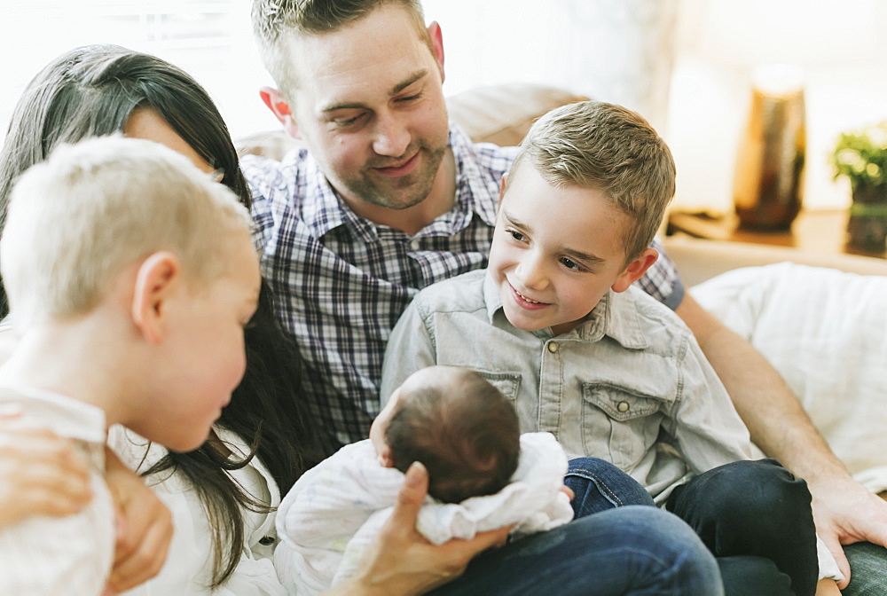 Young family spending time at home with a newborn baby girl, Surrey, British Columbia, Canada