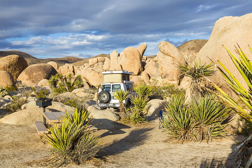 View of a campsite with a Sportsmobile Van in Joshua Tree National Park, California, United States of America