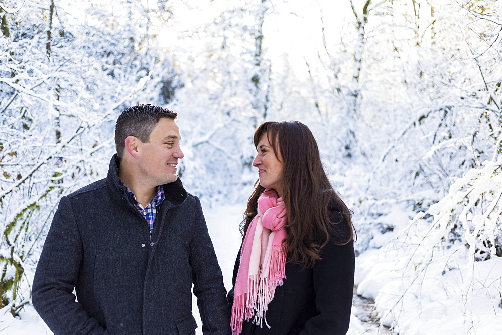 A couple standing together outside on a snowy trail, Surrey, British Columbia, Canada