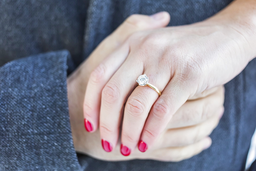 Diamond engagement ring with couple's hands clasped, Surrey, British Columbia, Canada