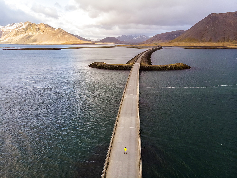 Man standing on bridge in Iceland. Image taken with a drone, Grundarfjorour, Iceland