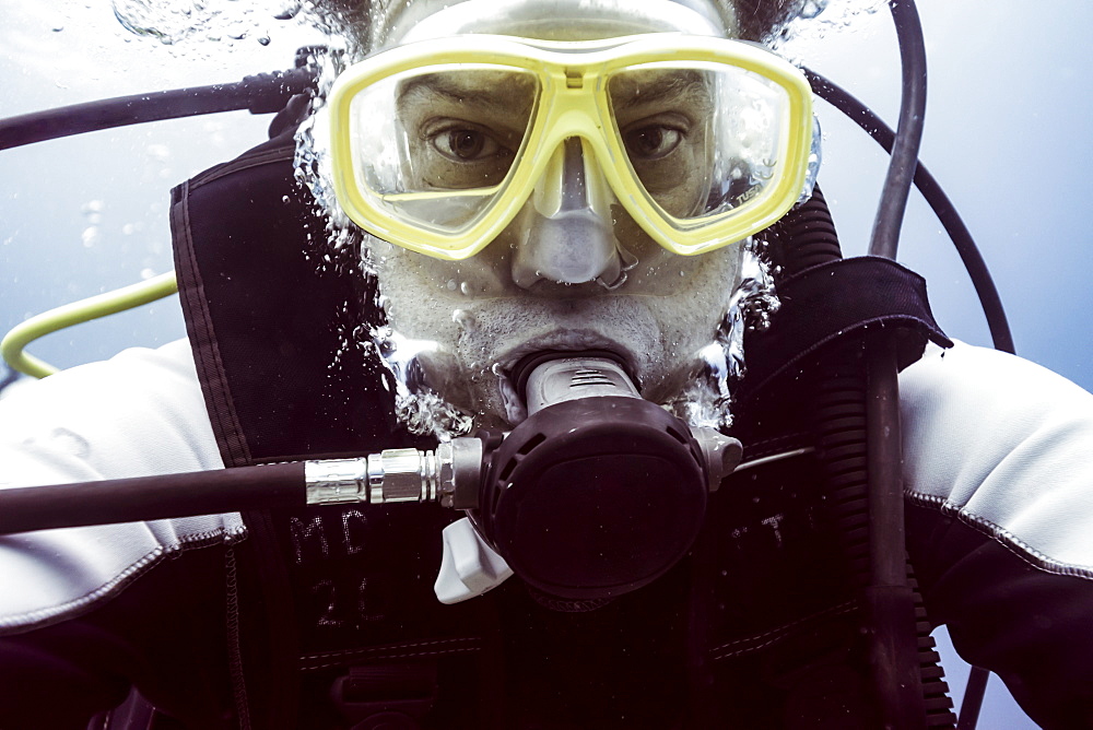 Scuba diver underwater looking at the camera, Belize