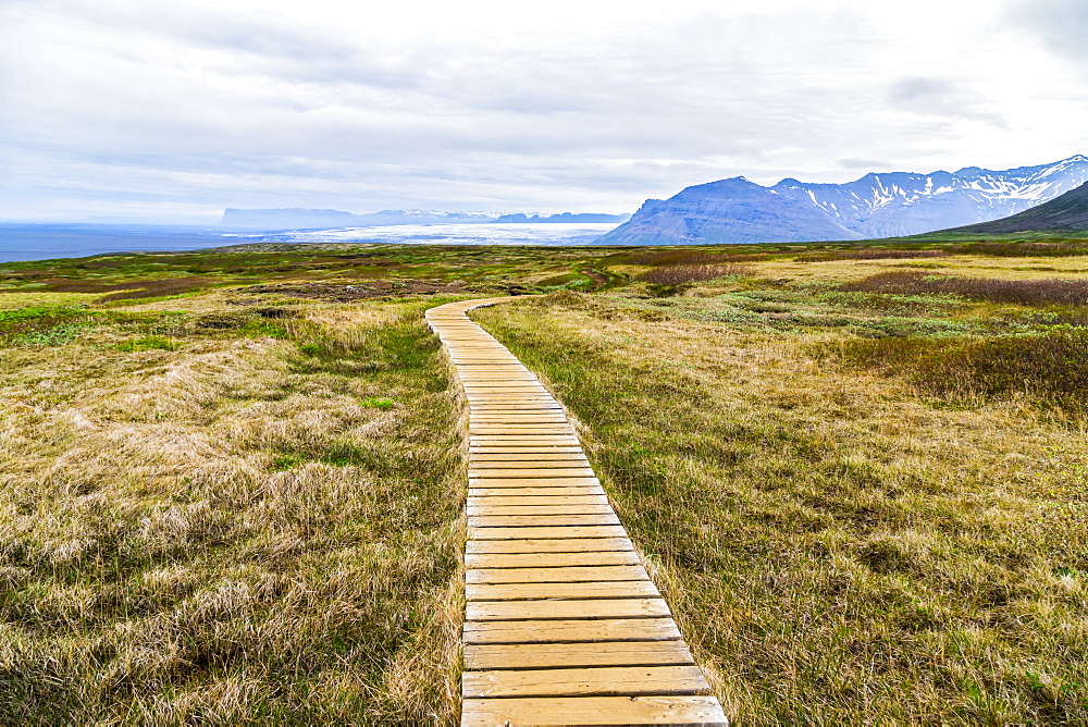 A boardwalk path leads hikers through the hiking route on the Vatnajokull National Park plateau, Iceland