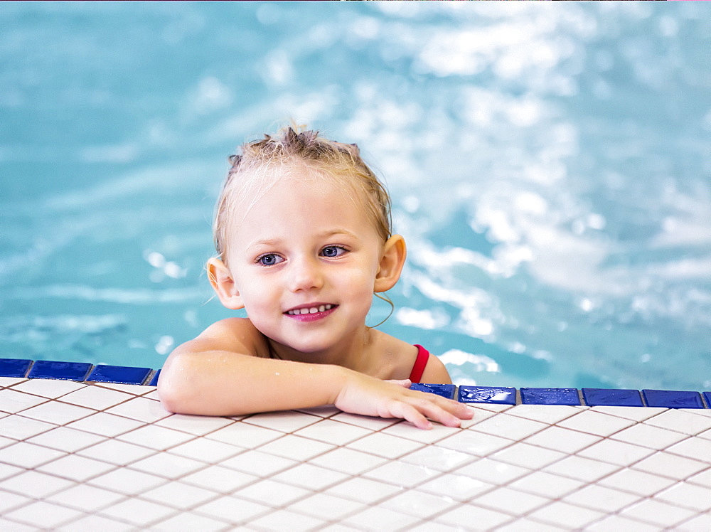 Young Girl Swimming On Her Own In An Indoor Swimming Pool, Spruce Grove, Alberta, Canada