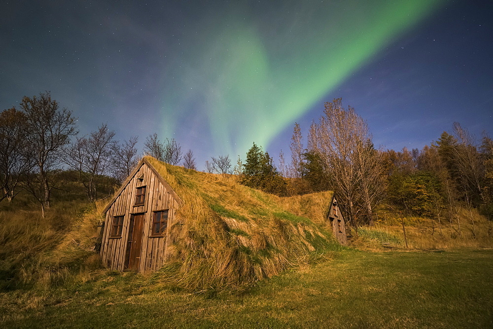Northern Lights over a sod house along the South coast of Iceland, Iceland