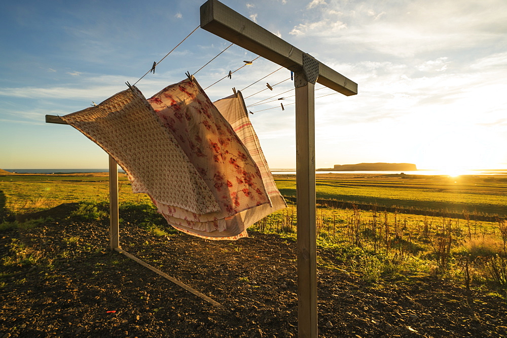 Fabric on a clothesline blowing in the wind at sunset, Vik, Iceland