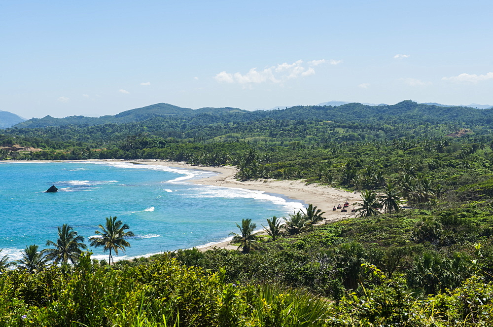 All-terrain vehicles riding along a beach at Amber Cove in the Caribbean, Dominican Republic