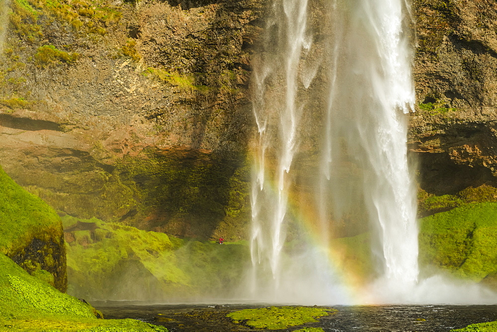 Seljalandsfoss waterfall and a rainbow in the mist, Iceland