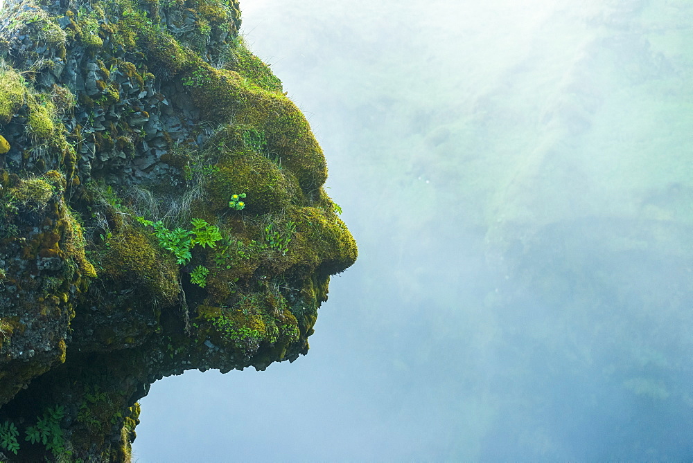 Shape of head and face in natural rocks beside Skogafoss waterfall, Iceland