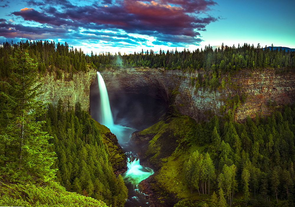 Illuminated waterfall flowing over a cliff in Wells Grey Provincial Park, Thompson-Nicola Regional District, British Columbia, Canada