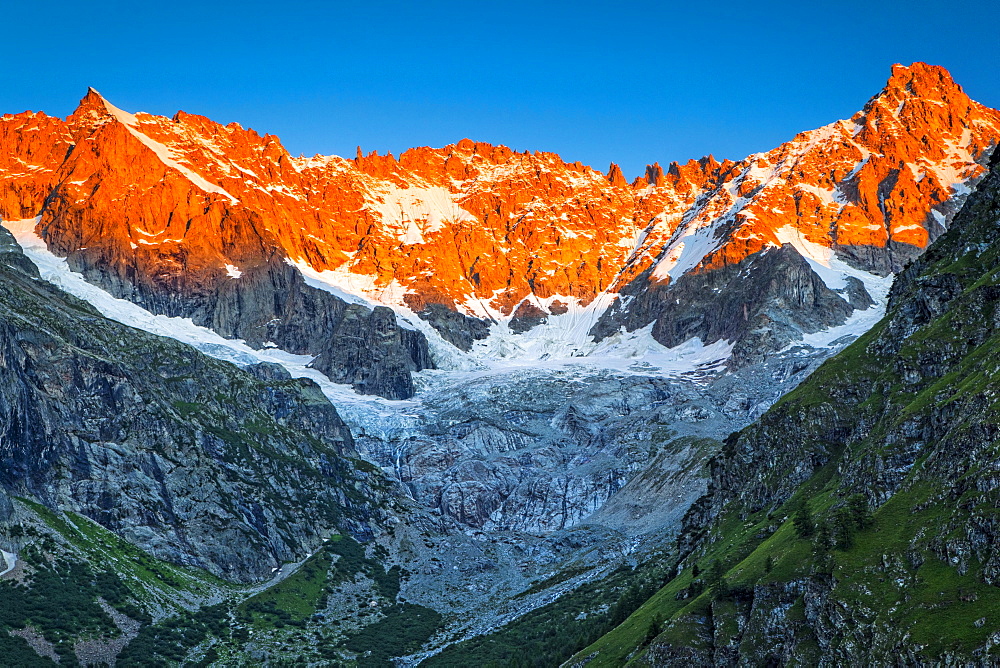 Sunrise glow on the peaks above l'A Neuve Glacier, viewed from La Fouly, Swiss Val Ferret, Alps, La Fouly, Val Ferret, Switzerland