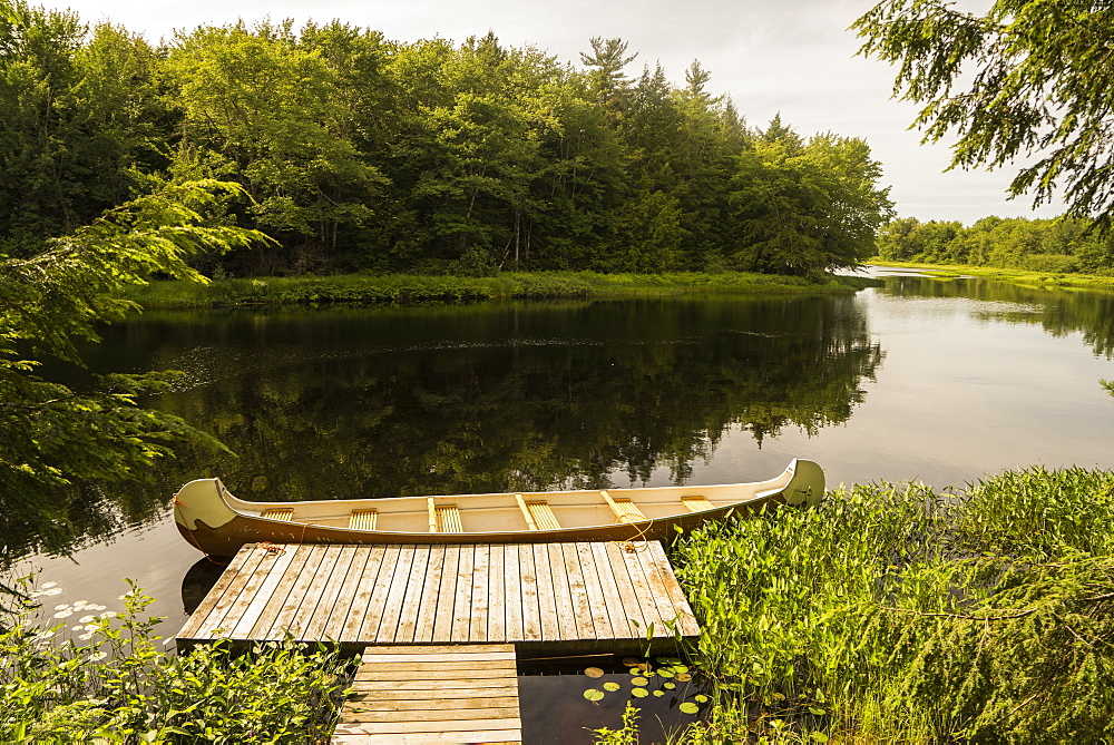 A canoe sitting along a dock in Mersey River, Kejimkujik National Park, Nova Scotia, Canada