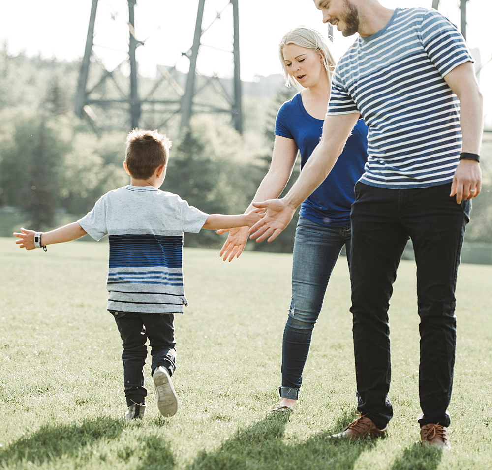 A family with young son playing in a park, Edmonton, Alberta, Canada