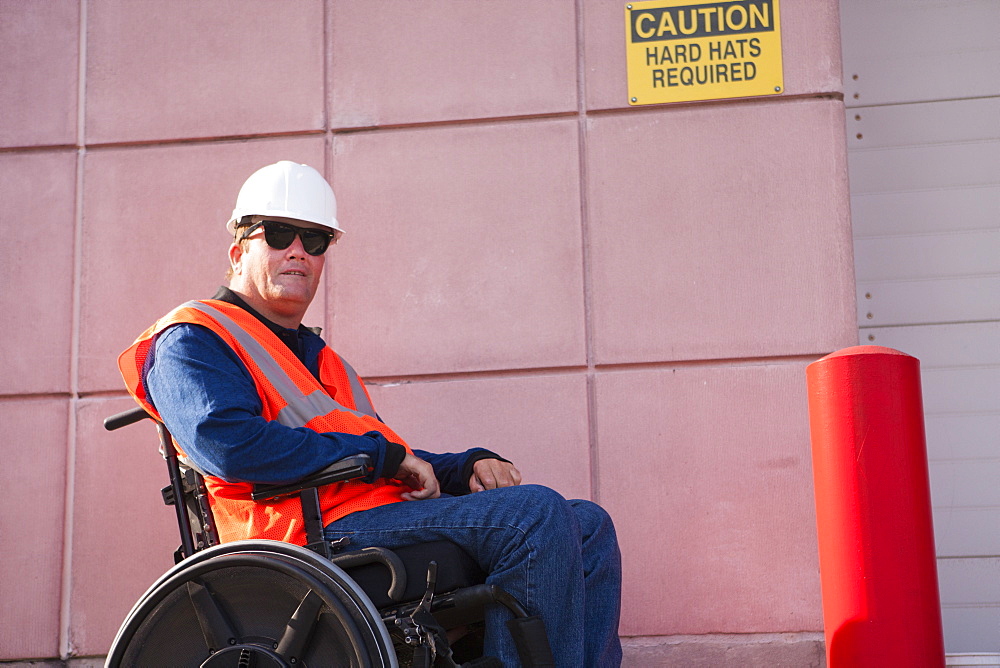 Facilities engineer in wheelchair at hard hat area