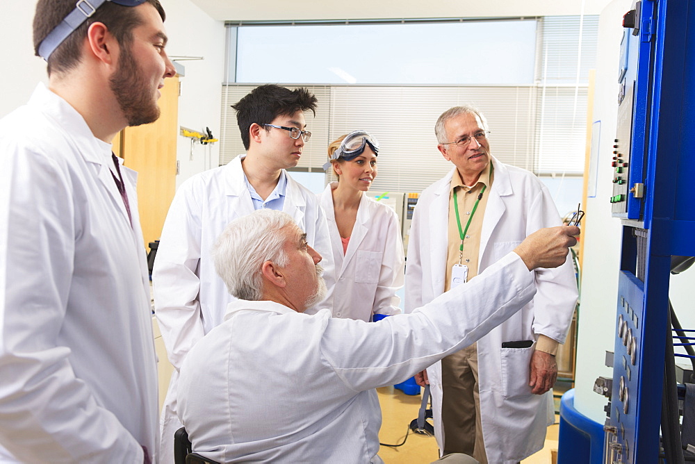 Professors explaining operation of water ultra purification system to engineering students in a laboratory