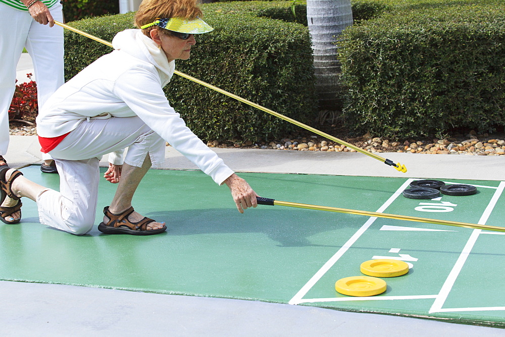 Senior women playing shuffleboard