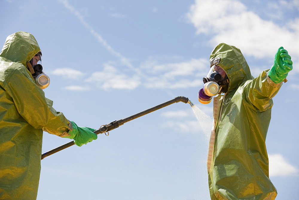 HazMat firefighter getting decontamination wash