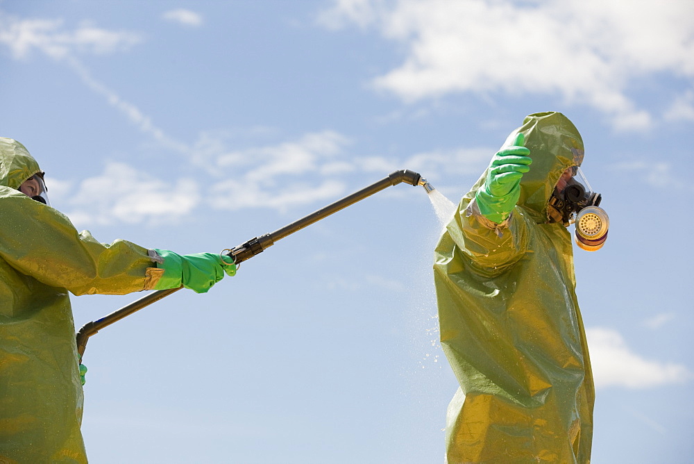 HazMat firefighter getting decontamination wash