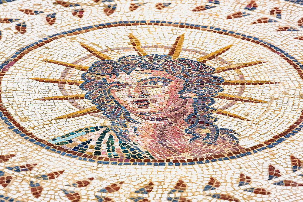 Tiled artwork of medusa, Roman ruins of street art; Spain