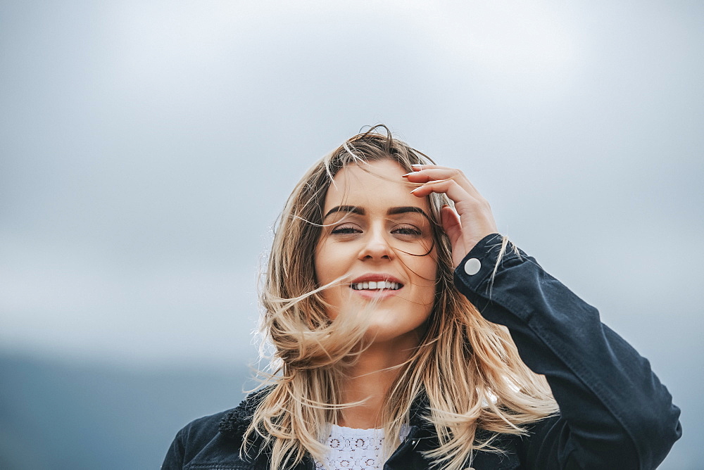 Portrait of a beautiful young woman with windblown hair; Wellington, North Island, New Zealand