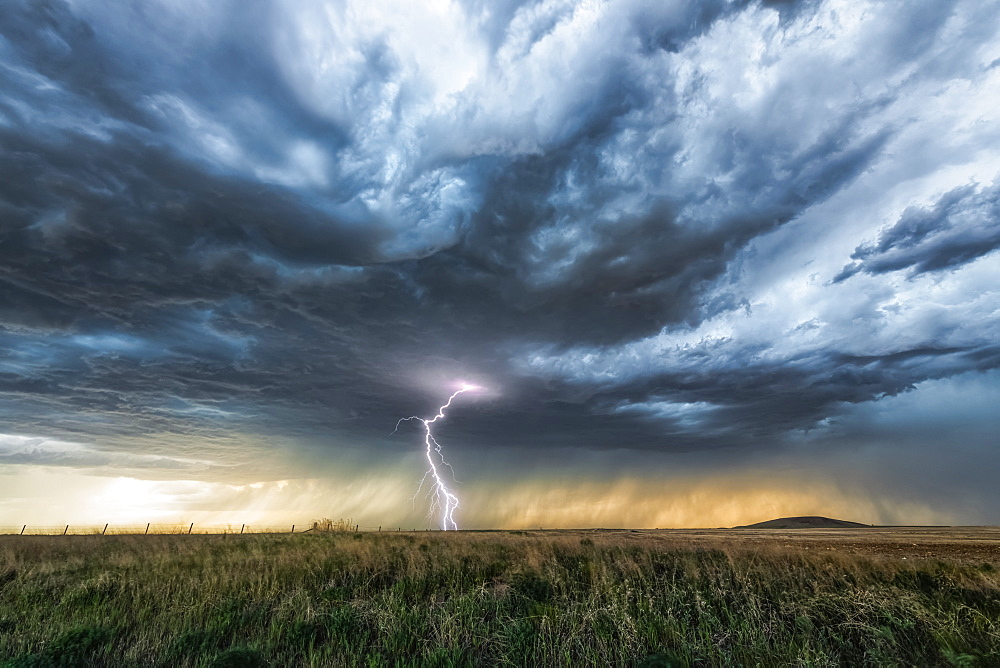 Lightning strike on the horizon during an electrical storm on the prairies; Saskatchewan, Canada