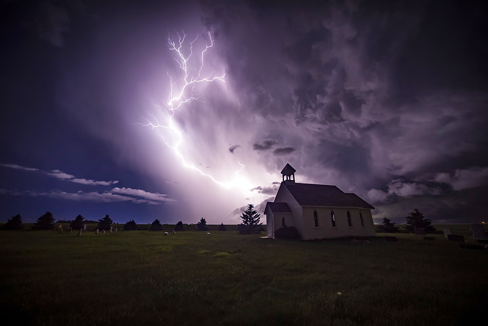 Beautiful and bright electrical storm with a church in the foreground; Moose Jaw, Saskatchewan, Canada