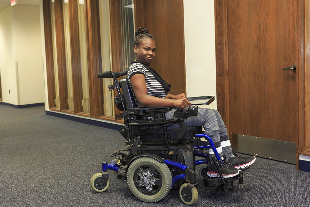 Teen with Cerebral Palsy in hallway of school